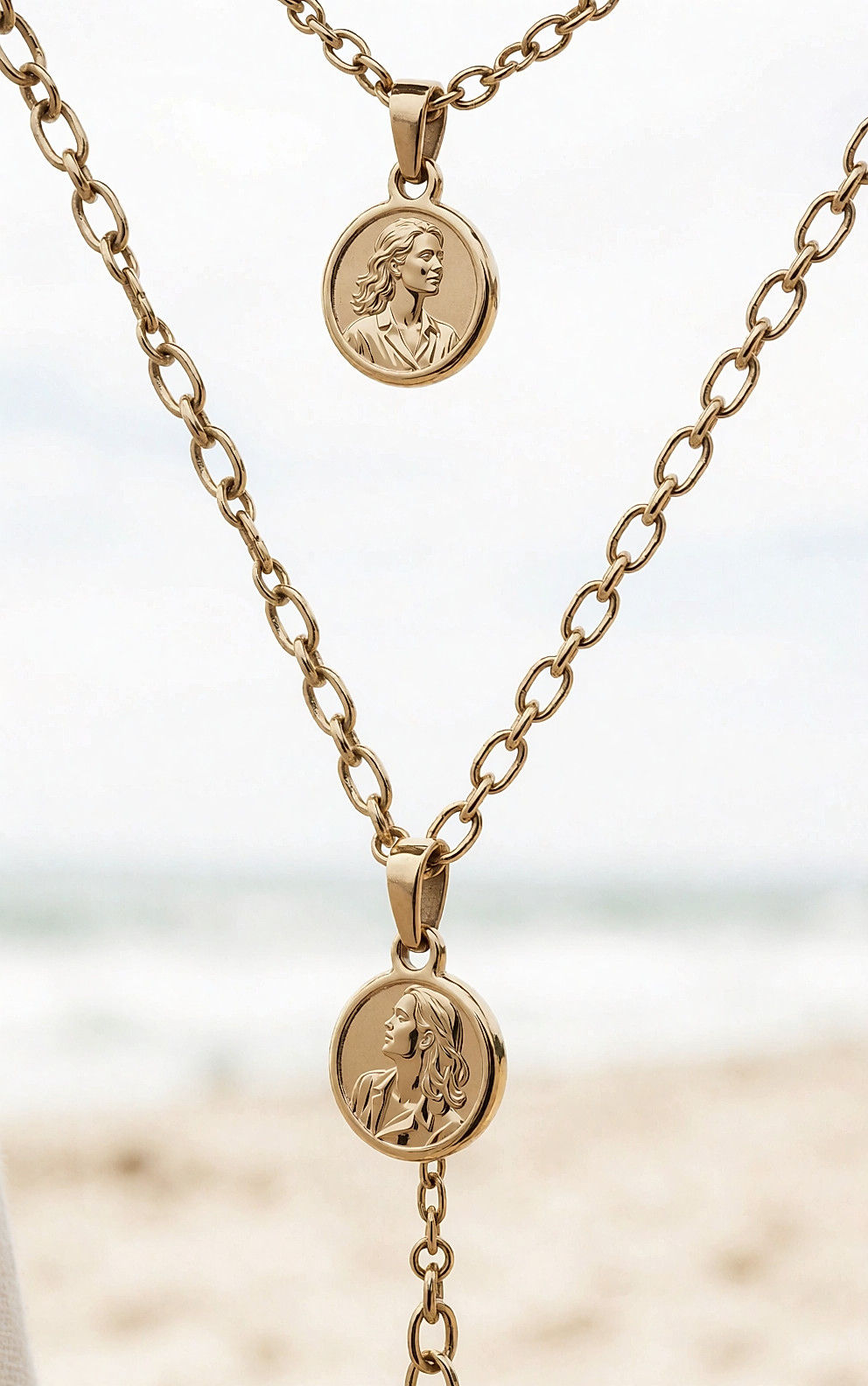 Détail d'un collier doré à pendentif porté sur une chemise en lin