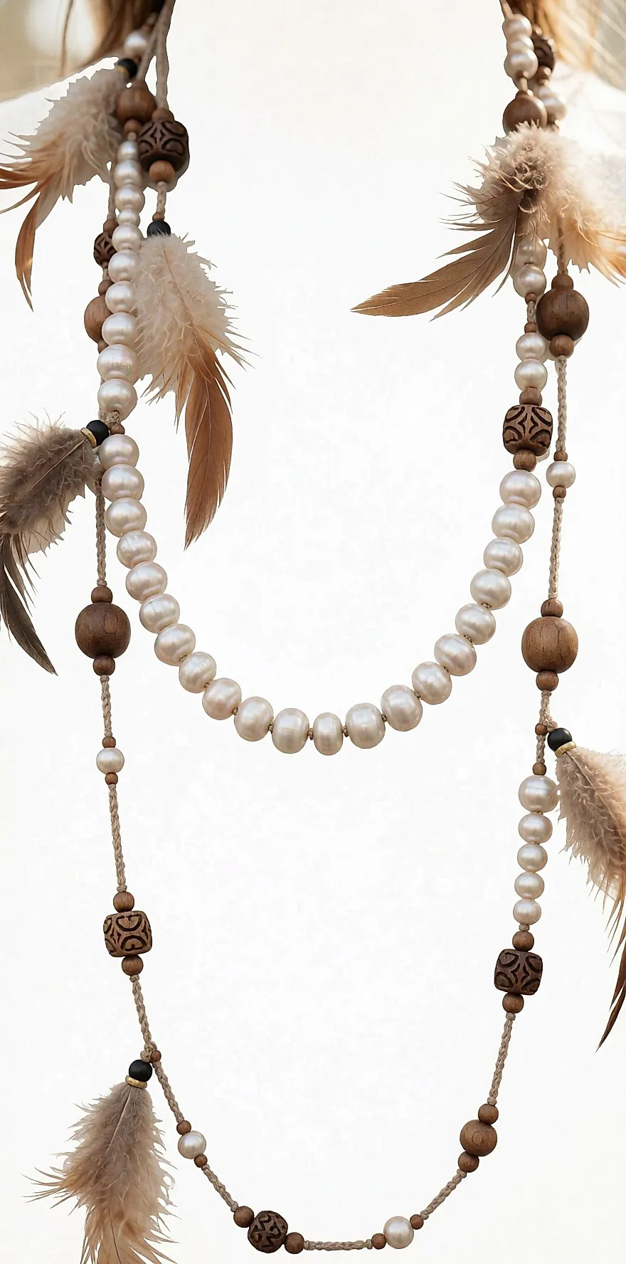 Lange Boho-Kette mit Perlen, Holzperlen und Federn über einem feinen Pullover