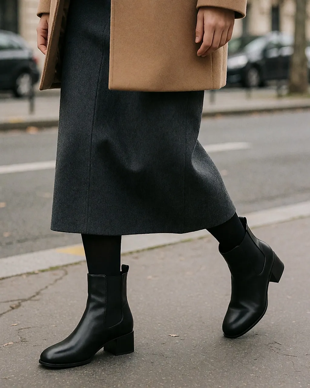 Schwarze Lederstiefelette mit runder Spitze und kleinem Blockabsatz, getragen mit Midirock und blickdichten Strumpfhosen