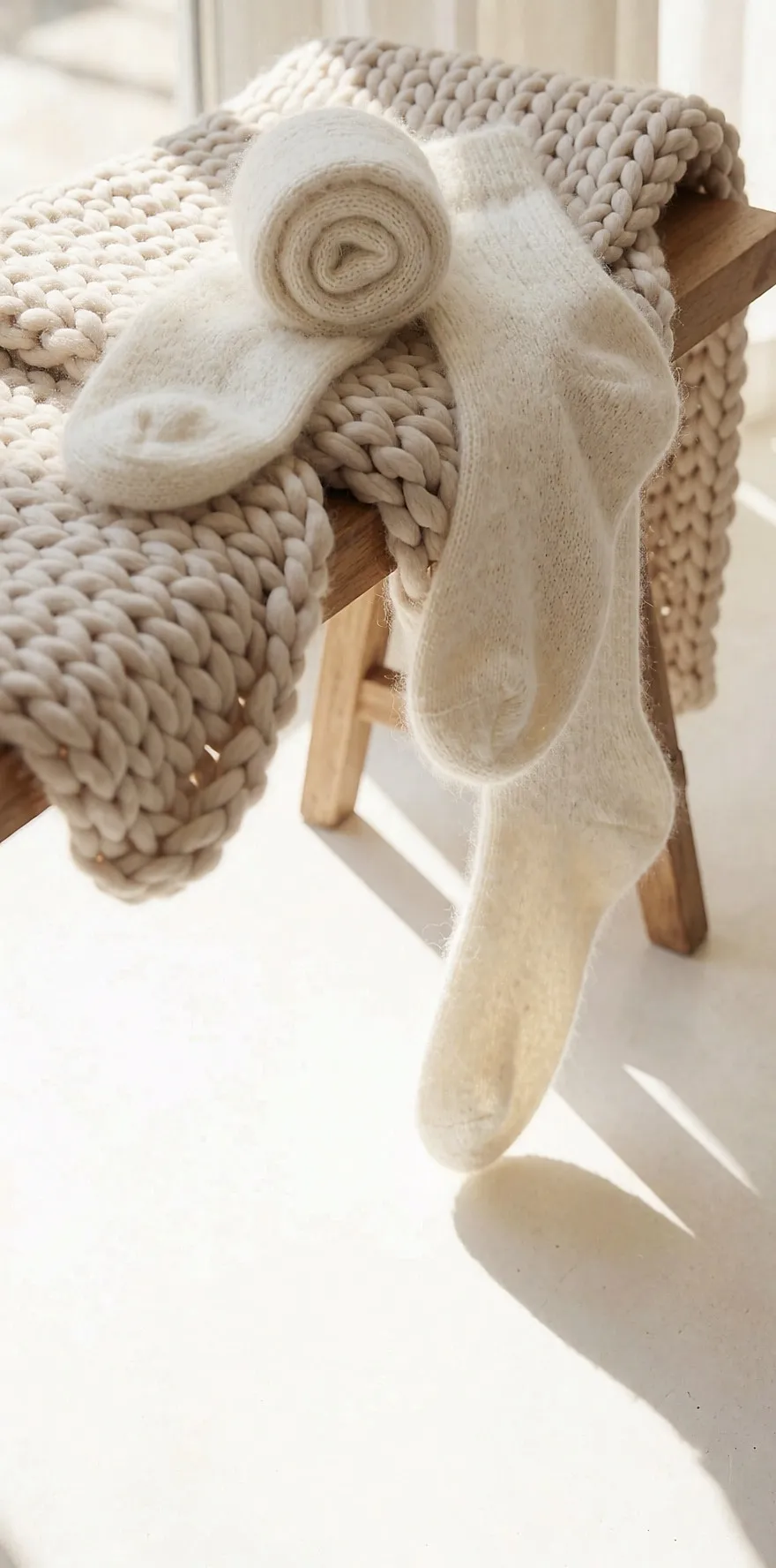 Pair of soft wool socks on a chunky knit throw