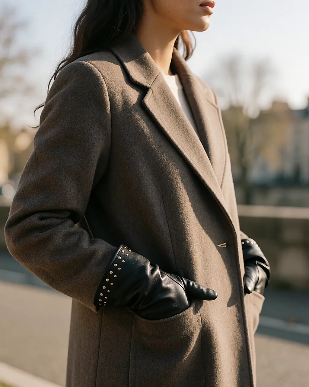 Black leather gloves studded at the wrists, hands in pockets