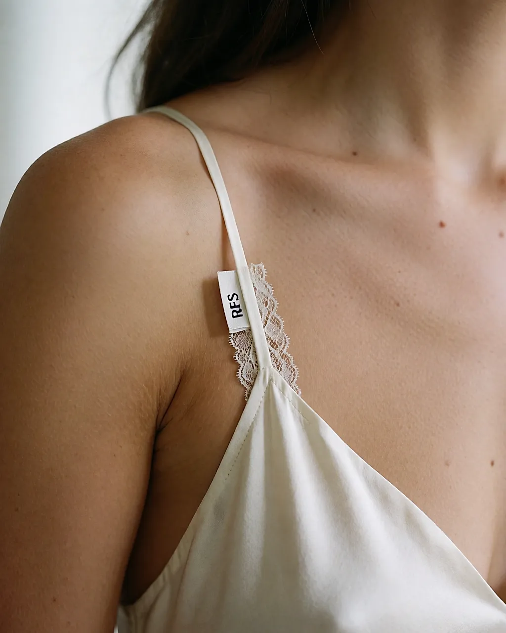 Close-up of a strap and lace detail on the shoulder of an Eres nightdress