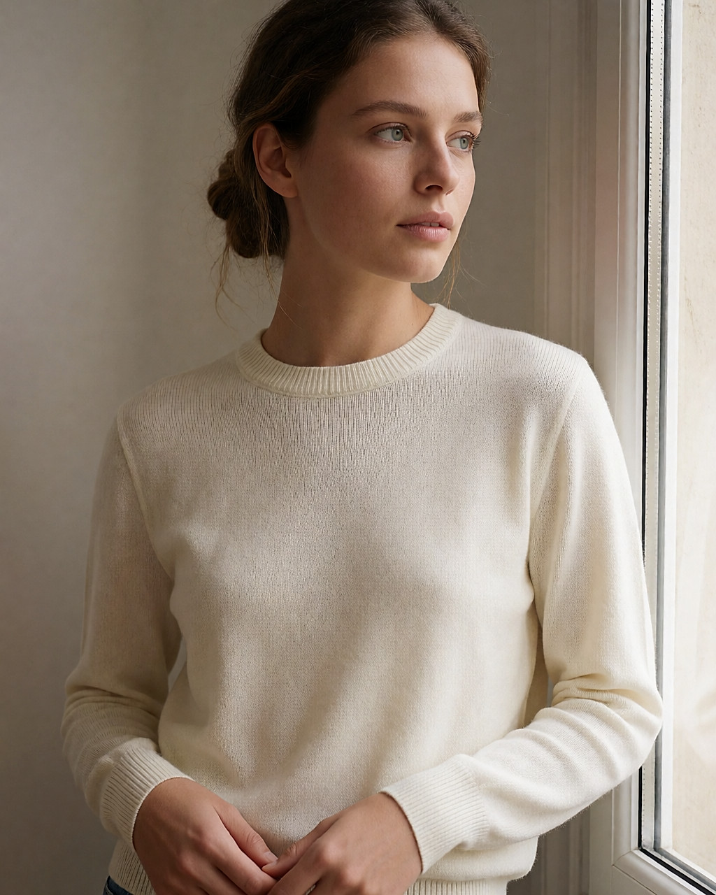 Worn ecru merino jumper, fluid drape and visible ribbing in natural light