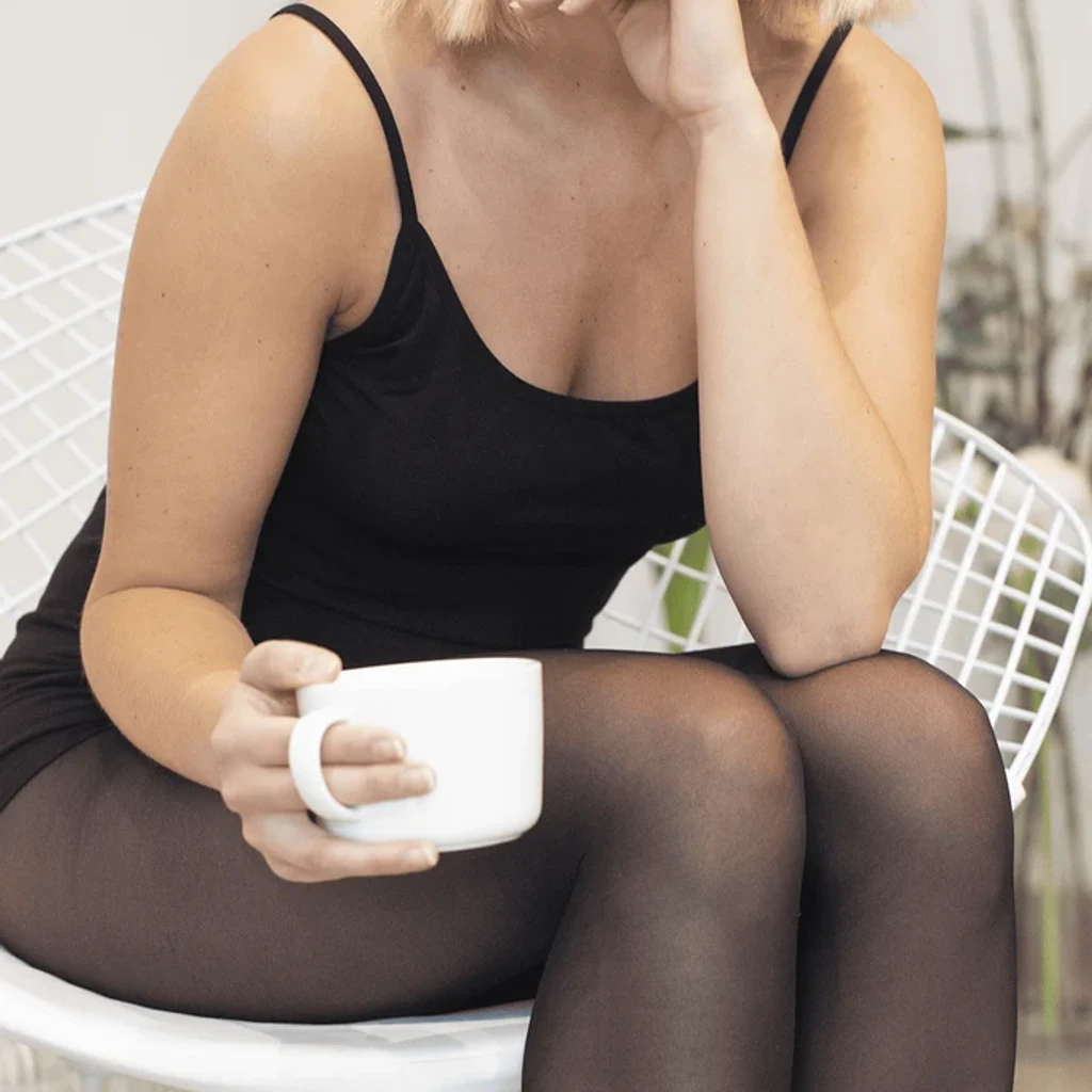 Black cami top with fine straps worn by a model