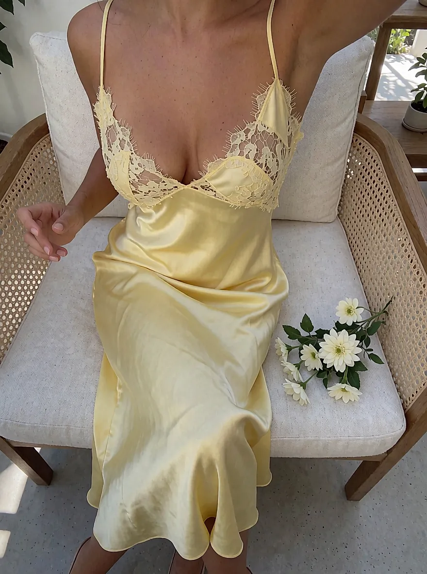 Product photo inspired by a women's midi dress in butter-yellow satin with lace and patchwork