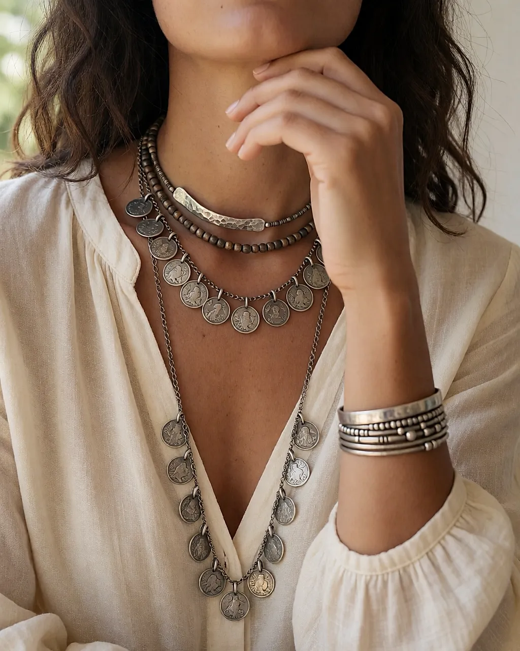 Layered boho jewellery: coin necklace, choker and bracelets